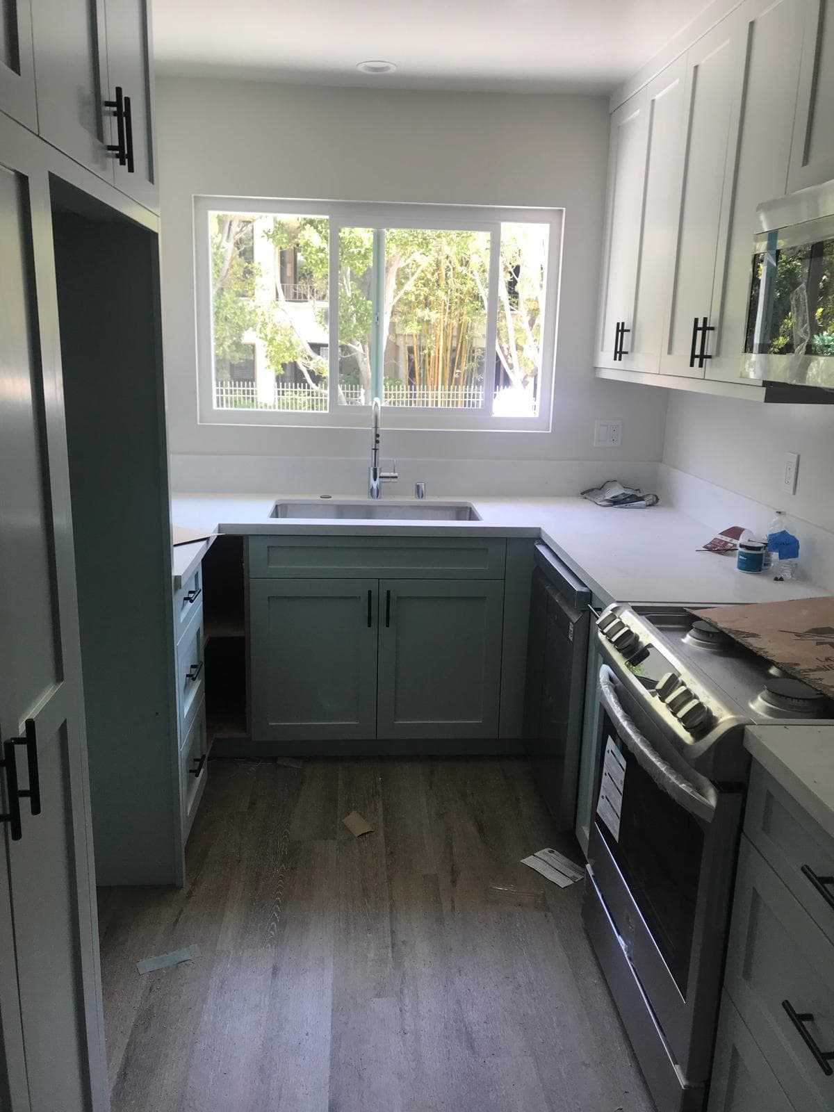 Modern gray kitchen cabinets with stainless appliances in Los Angeles